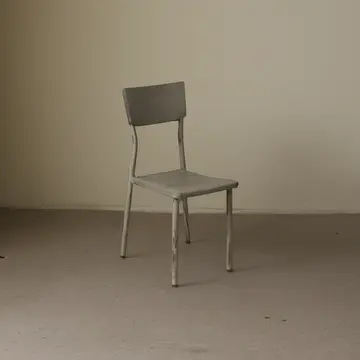 Stacked folding chairs in Lobby service entrance. The room is set for a meeting that has been postponed indefinitely. Dust motes in shafts of light