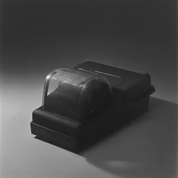Thermal receipt printer in Utility counter near main exit. The printer spits out labels that curl toward one specific point. Black plastic casing of printer