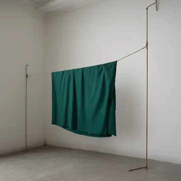 Windowed drying rack in Utility washroom corner. A sheet is draped across the rack, slightly off-kilter. Wet lint buildup on the floor grate