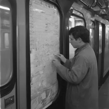 Clipboard with printed schedule in Subway utility office. A worker rereads the same section of the timetable multiple times. Yellowed paper edges