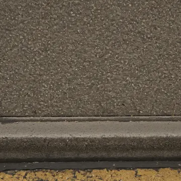 A collection of discarded ticket stubs and gum residue in Subway platform during a scheduled delay. Passengers navigate around an accumulation of sticky, patterned debris. Yellowed...