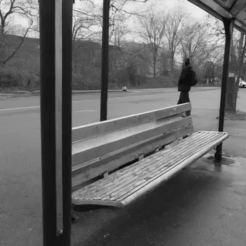 The unwritten seating arrangement rule in Public transit waiting shelter. People are maneuvering to board the bus, but the designated standing spots seem to shift slightly with...