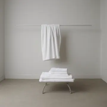 Folded linen stacks in Utility room shelving unit. A person is methodically straightening towels and sheets. Yellow plastic hangers