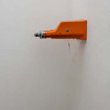 Weather gauge unit in Utility closet corner. Measuring accumulated condensation drips. Rust-stained metal shelf bracket