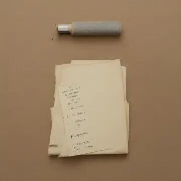 Manila folder stack in Records management office. A filing routine is interrupted by misplaced labels. Dust motes on beige paper